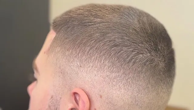 A short textured cut with a fade, close up