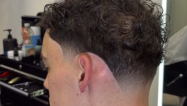 Curls with a taper fade and a sharp line-up